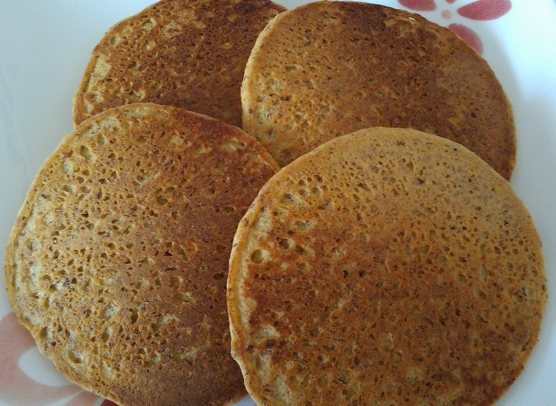 almond meal pancakes, overlapping on a plate
