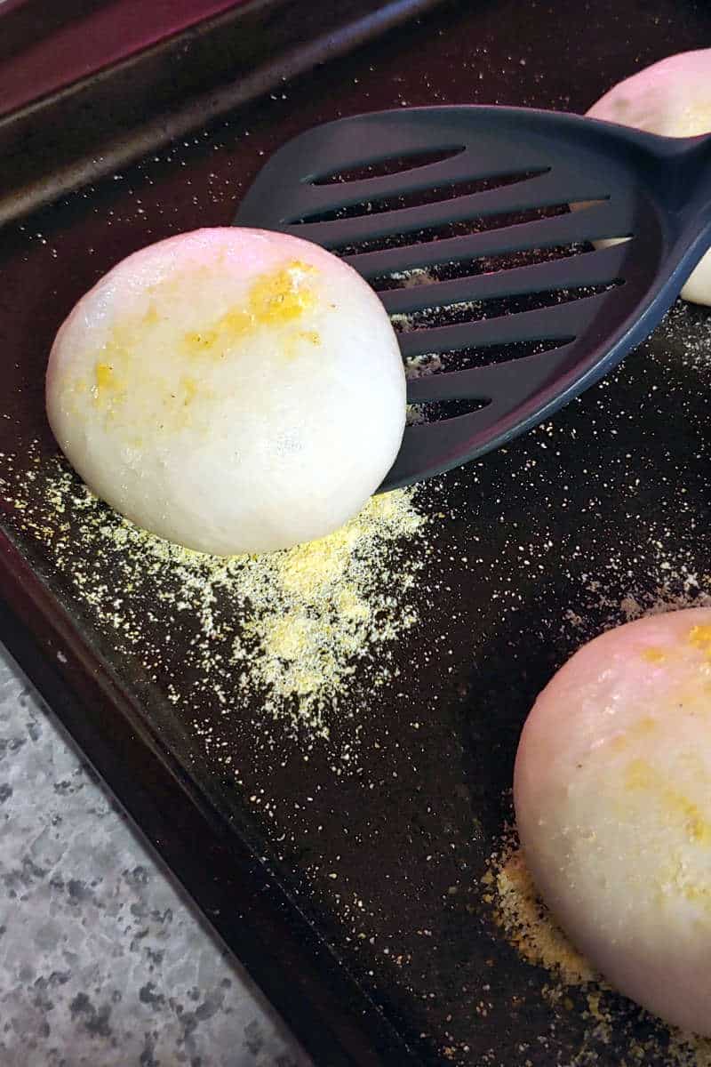 english muffin, being transferred to an electric griddle