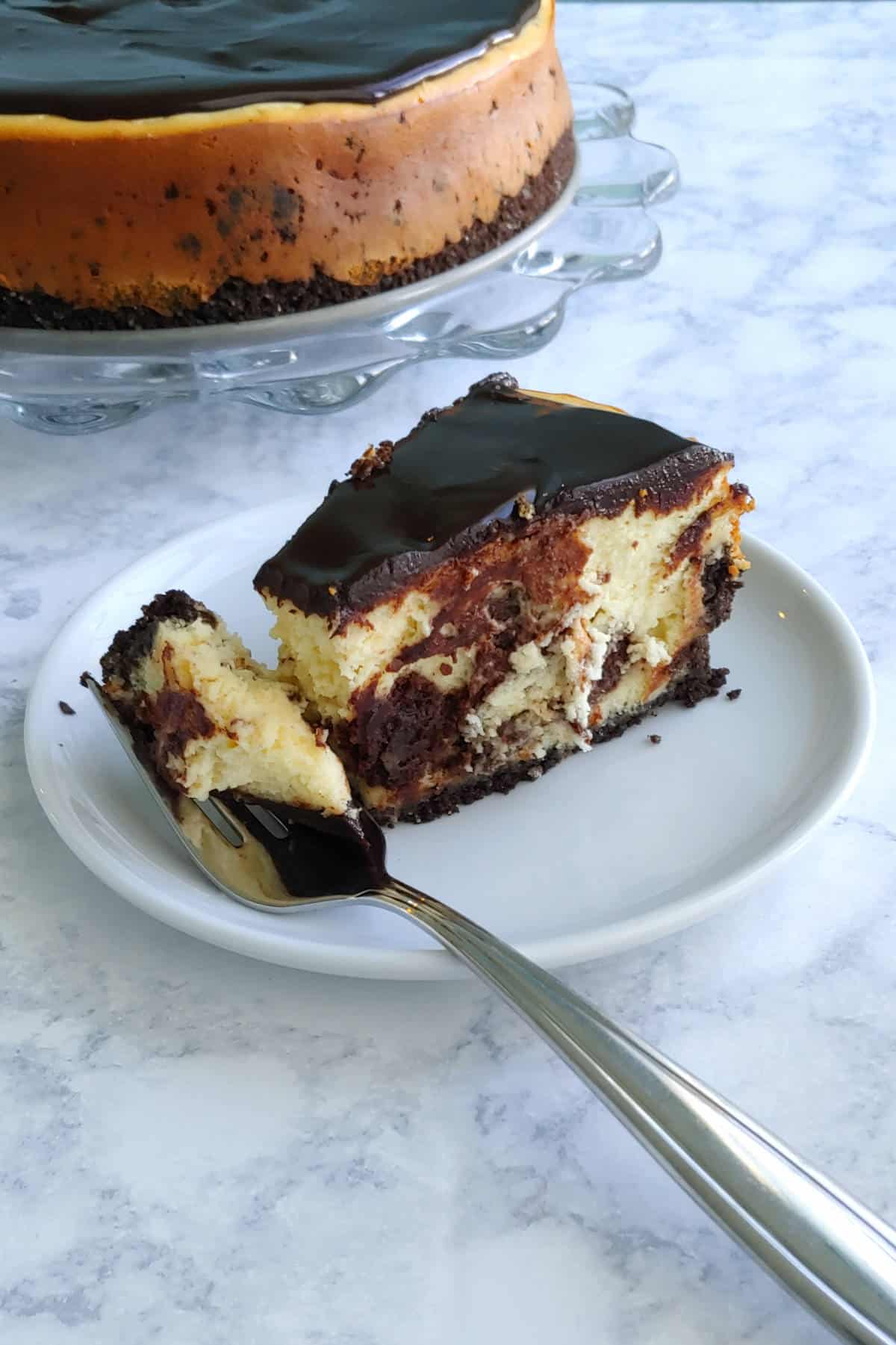 slice and bite of cheesecake, in front of the whole